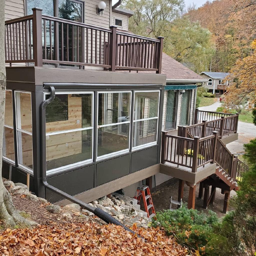Three-season sunroom addition with windows and wood finish by IW Brothers
