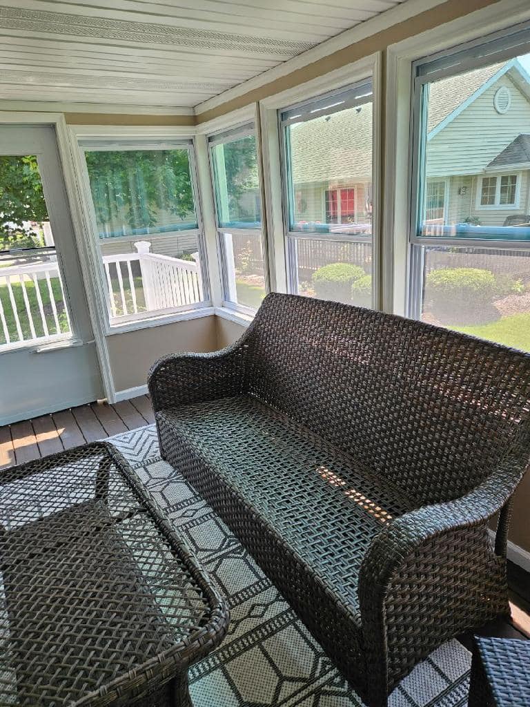 Three-season sunroom addition with windows and wood finish by IW Brothers