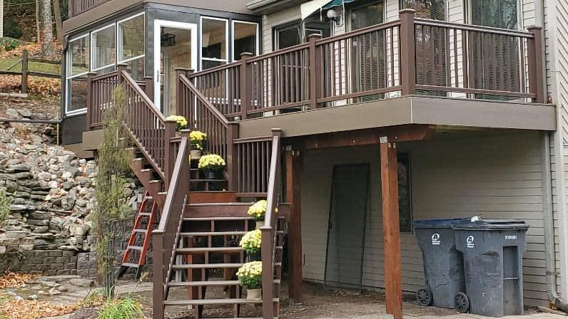 Three-season sunroom addition with windows and wood finish by IW Brothers